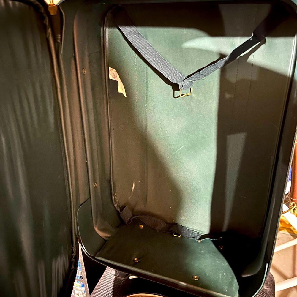 Green small suitcase used for carry on.